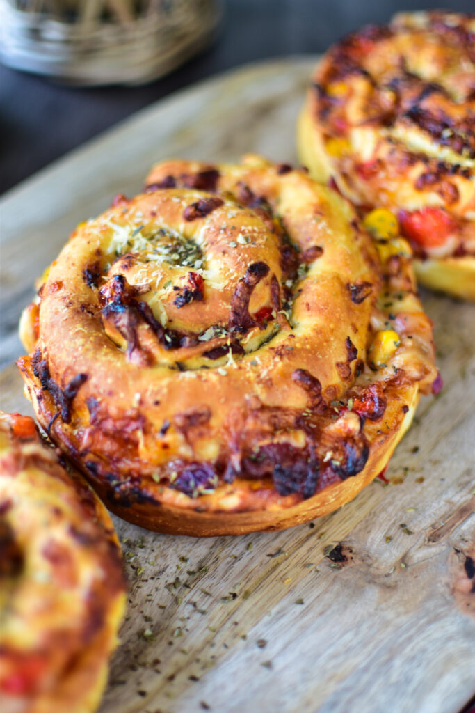 Detailbild der Pizzarollen aus der HLF auf einem Holzbrett.